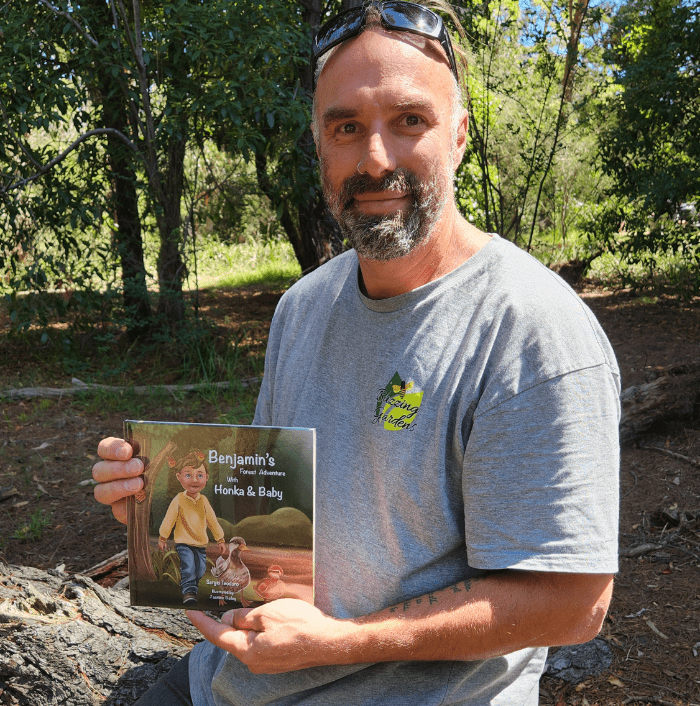 Author holds Forest book